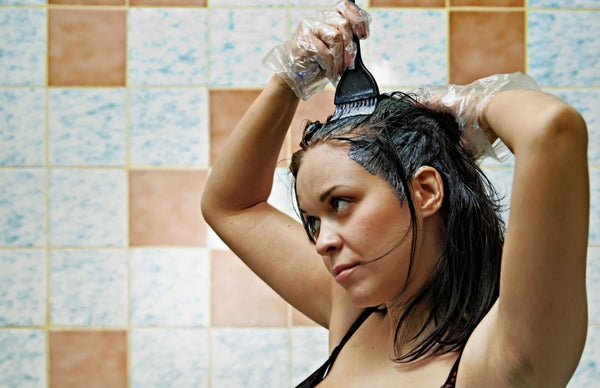 women coloring her hair at home